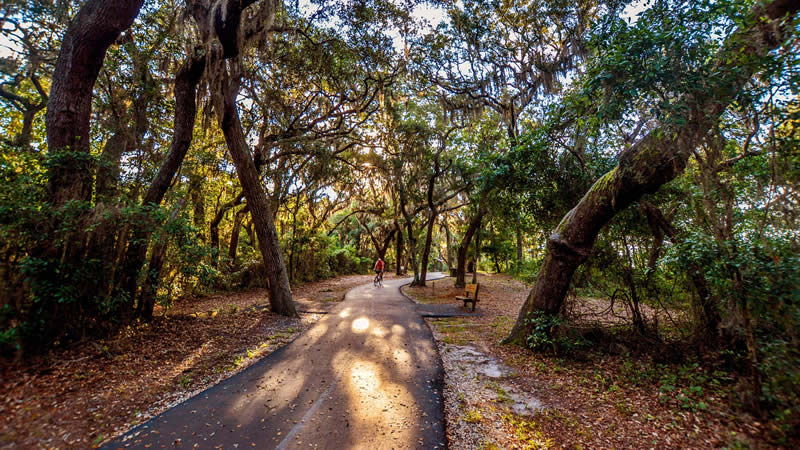 man cycling on trail